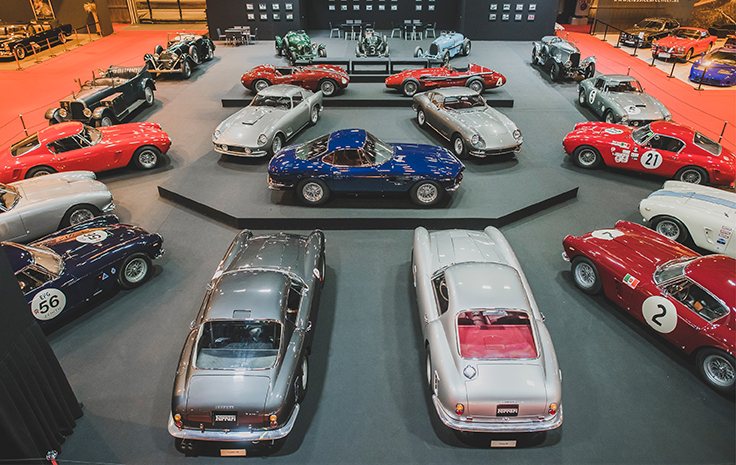 Ferrari and Aston Martin automobiles on the 2018 stand
